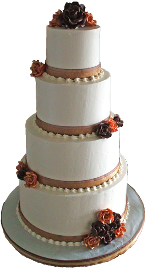 4 tier buttercream wedding cake with brown and gold ribbons, brown and gold chocolate flowers and buttercream shell borders