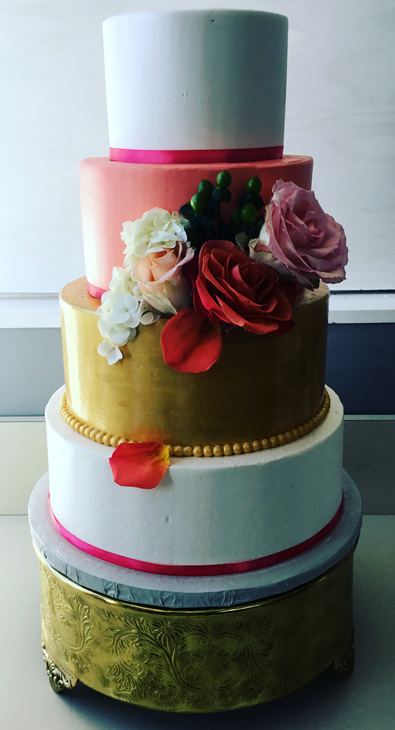 4 Tier ivory, coral and gold buttercream wedding cake decorated with fresh flowers