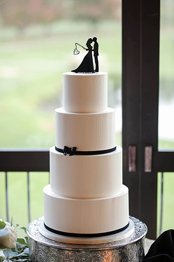 4 Tier smooth buttercream wedding cake decorated with black ribbons and a small black bow, delivered to Heritage Hills, York PA