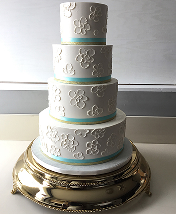 4 Tier buttercream wedding cake decorated with buttercream brushed embroidery and turquoise and gold ribbons, delivered to Heritage Hills, York PA