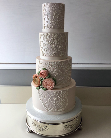 4 Tier buttercream wedding cake, pearlised decorated with buttercream lace, buttercream flowers and ribbons
