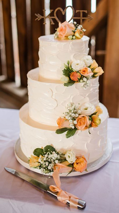 3 Tier rustic textured buttercream wedding cake, decorated with fresh flowers