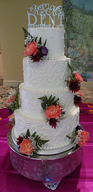 4 Tier buttercream wedding cake, decorated with Swiss dots, scrolls, quilt pattern design and fresh flowers, delivered at the Felicita Resort Harrisburg PA