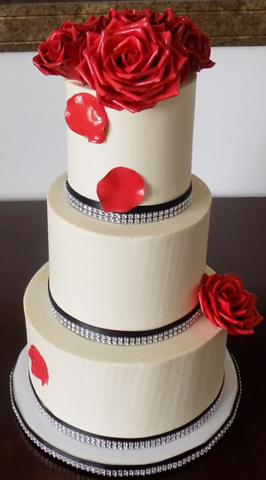 3 Tier marble buttercream wedding cake, filled with raspberry preserve and ganache and decorated with black and bling diamond ribbons