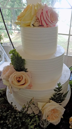 3 Tier rustic textured buttercream wedding cake decorated with fresh flower, delivered at Historic Shady Lane. Wedding Cakes Manchester PA