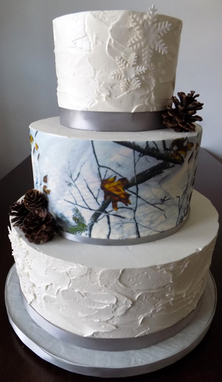 3 Tier textured buttercream wedding cake, decorated with edible camo image, silver ribbons, pine cones and snow flakes, delivered to the Monaghan Township Volunteer Fire Company in Dillsburg PA.