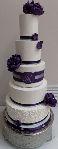 5 Tier buttercream wedding cake, decorated with purple, silver and diamond ribbons, buttercream scrolls and handmade purple sugar peonies - wedding cakes Harrisburg PA