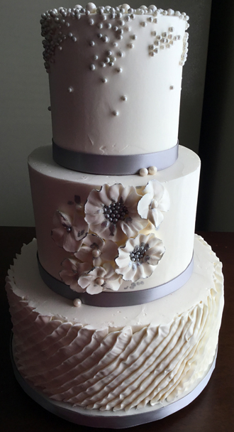 3 Tier buttercream wedding cake decorated with buttercream pleats, silver and pearl sugar pearls/dragees and buttercream flowers with silver high lights - bridal shower cakes York Lancaster PA<br />
<em>Wedding Cakes Lancaster PA</em>