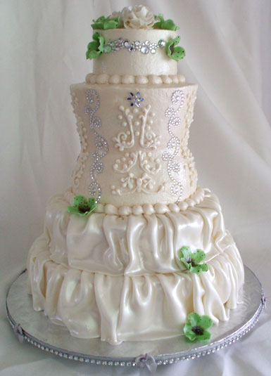 A buttercream and fondant wedding cake carved to resemble bride in a wedding dress