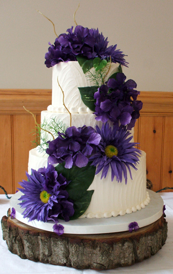 3 Tier textured buttercream wedding cake, decorated with purple silk hydrangeas and sunflowers - Wedding Cakes Felton PA